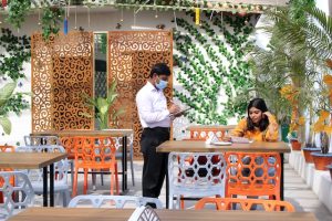 waiter collecting order from the customer at an Indian restaurant